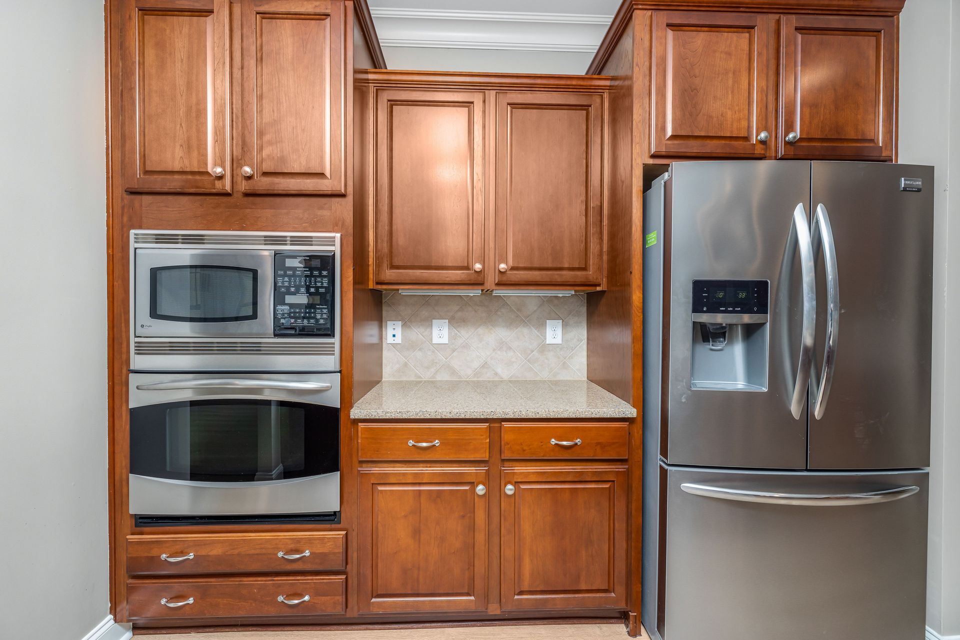 Elegant kitchen featuring stainless steel appliances and wooden cabinets.